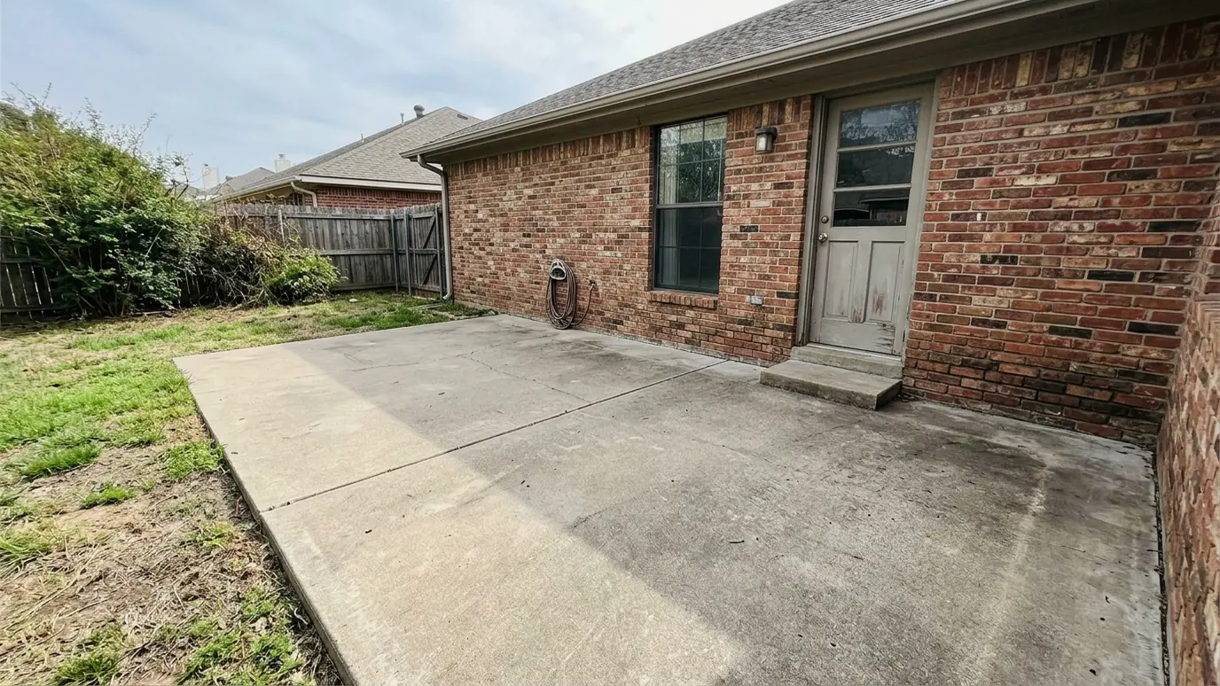 Before: a patio with a bare slab with no place to cook