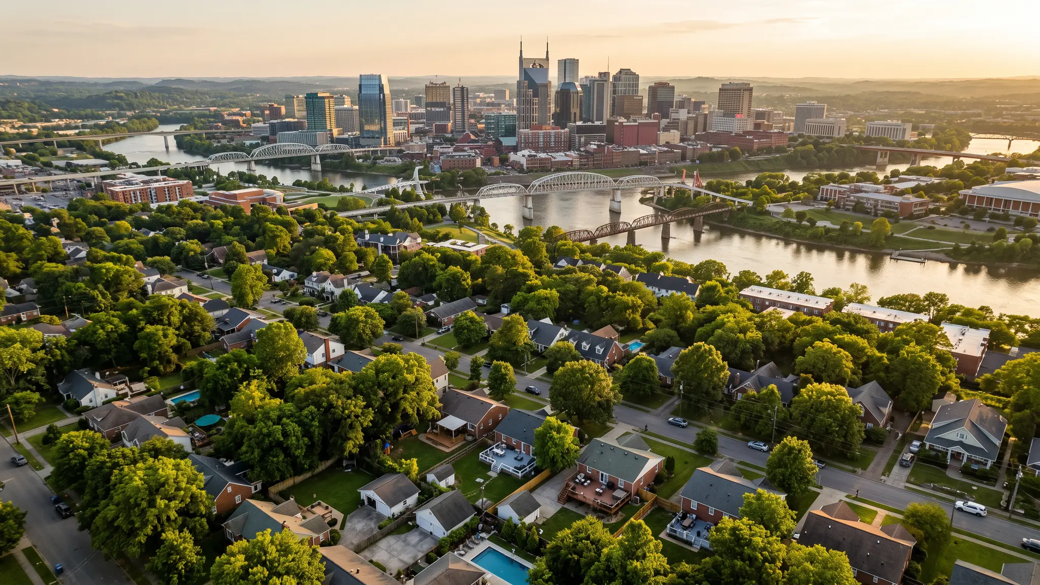 Aerial view of the Cumberland River winding past the Nashville skyline and Middle Tennessee farmland at sunset